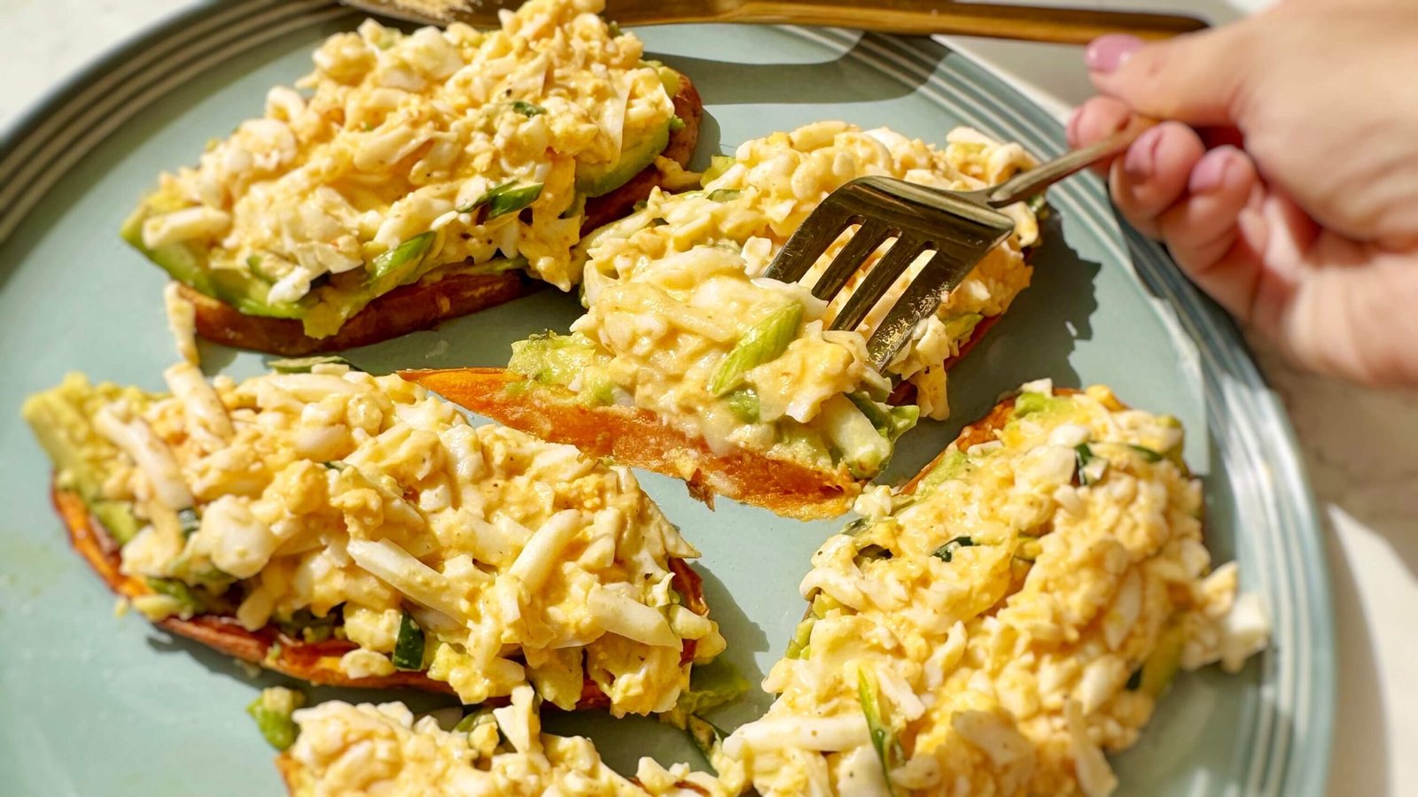 Grated Egg Sweet Potato Toast served on a plate, with a closeup