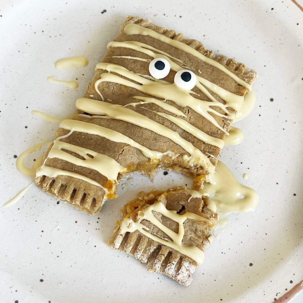 Pumpkin Pop Tart on a plate with white chocolate drizzled