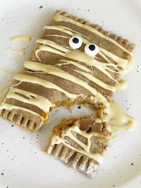 Pumpkin Pop Tart on a plate with white chocolate drizzled