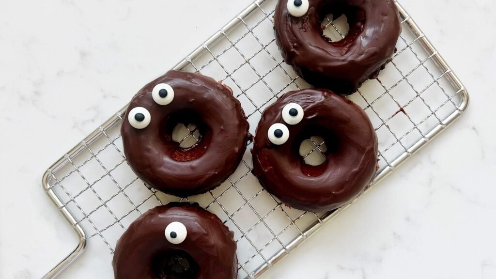 Chocolate Apple Donuts arranged over a cooling rack