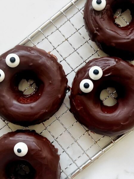 Chocolate Apple Donuts arranged over a cooling rack