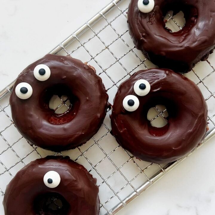 Chocolate Apple Donuts arranged over a cooling rack