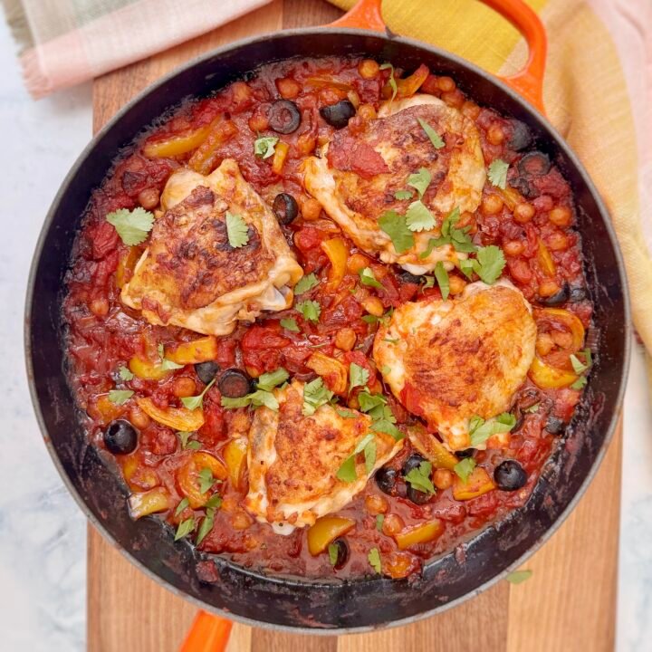 A rustic, Spanish-inspired one-pot chicken dish featuring golden-browned chicken thighs, smoky chorizo, tender chickpeas, sweet yellow peppers, and briny black olives, all simmered in a rich tomato sauce. Garnished with fresh parsley and served with lemon wedges, this hearty Mediterranean meal is both flavorful and nourishing. Perfect for an easy weeknight dinner or a cozy gathering.