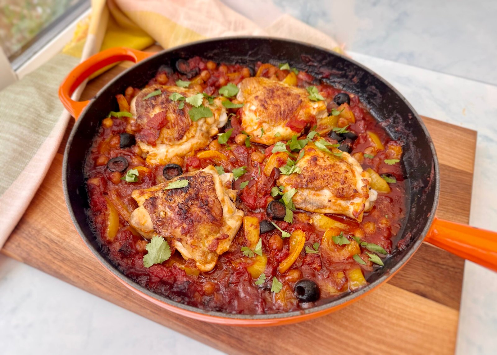 A rustic, Spanish-inspired one-pot chicken dish featuring golden-browned chicken thighs, smoky chorizo, tender chickpeas, sweet yellow peppers, and briny black olives, all simmered in a rich tomato sauce. Garnished with fresh parsley and served with lemon wedges, this hearty Mediterranean meal is both flavorful and nourishing. Perfect for an easy weeknight dinner or a cozy gathering.