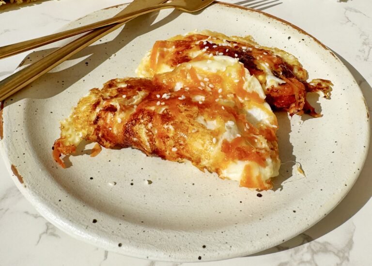 Crispy golden eggs with carrot, mozzarella and sesame seeds drizzled with hot honey, served fresh from the pan.