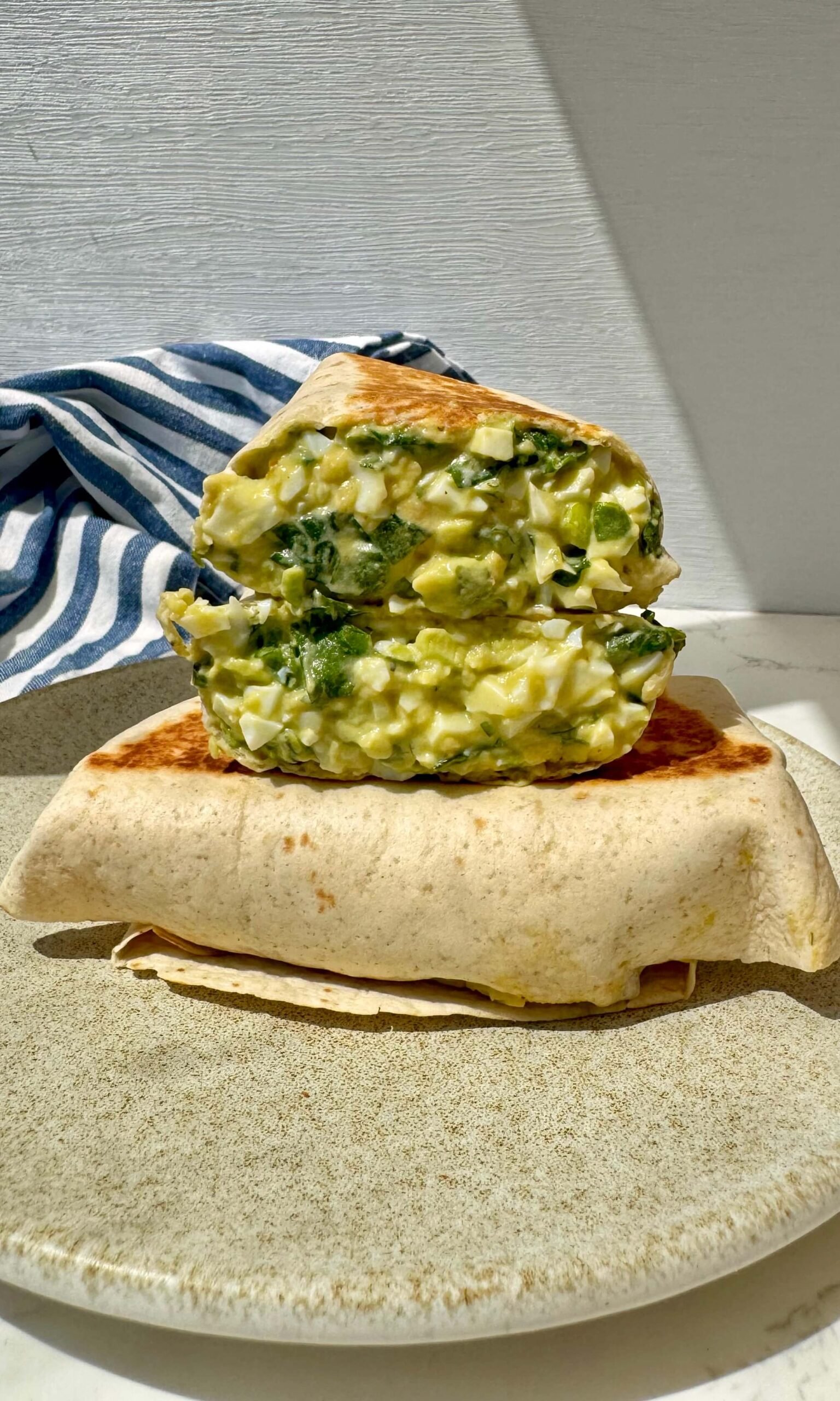 Chopped Egg Salad Wraps cut in half showing filling