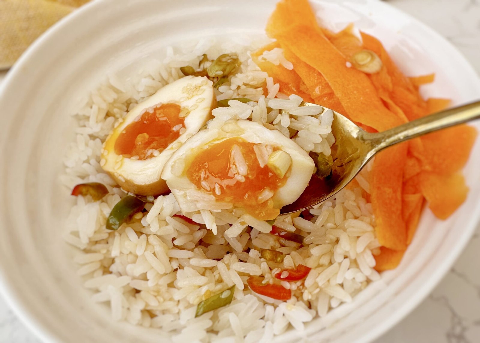 Jammy Korean Mayak Eggs halved on a plate, soaked in soy‑garlic marinade with sesame seeds, green onions and sliced chilli pepper.