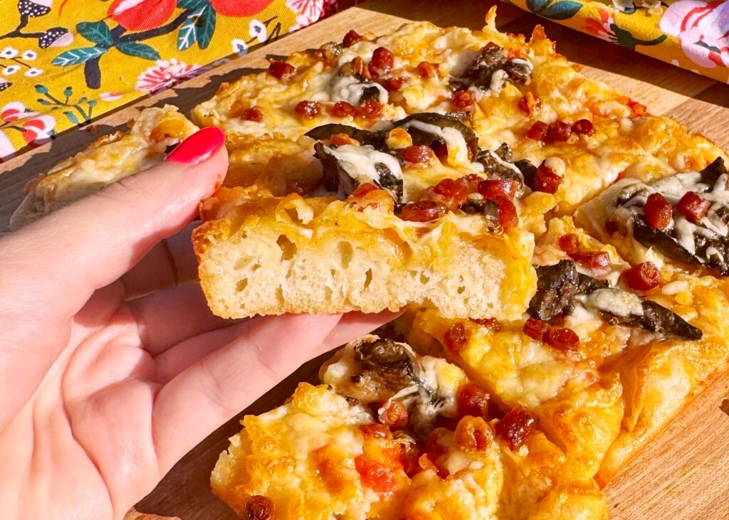 An easy, fluffy pizza focaccia topped with tomatoes, herbs, and cheese. A Mediterranean-inspired twist on classic focaccia – perfect for sharing.