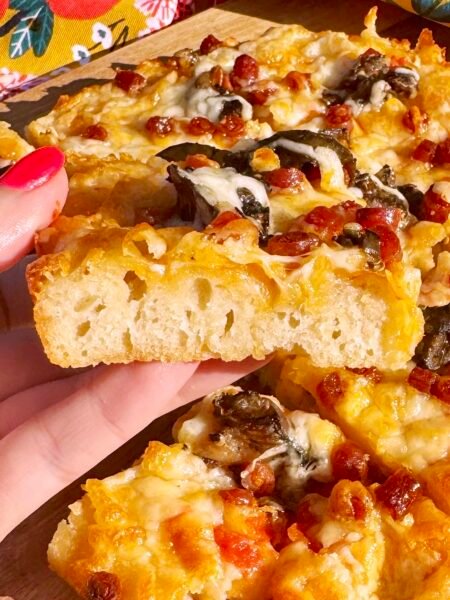 An easy, fluffy pizza focaccia topped with tomatoes, herbs, and cheese. A Mediterranean-inspired twist on classic focaccia – perfect for sharing.