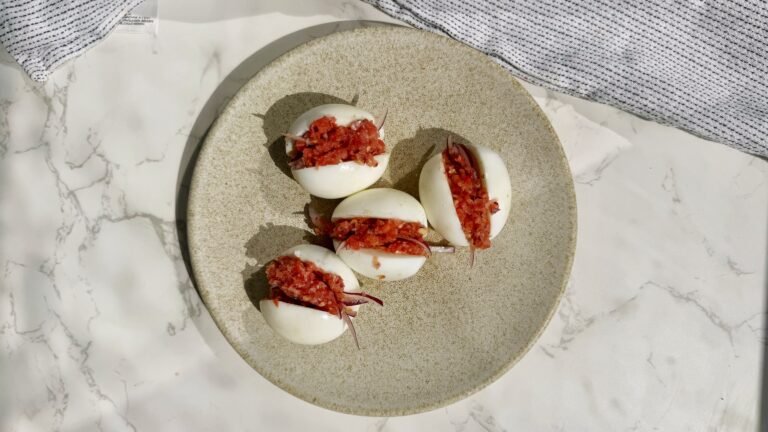 A plate with hard boiled eggs with a pepper relish called kosua ne meko