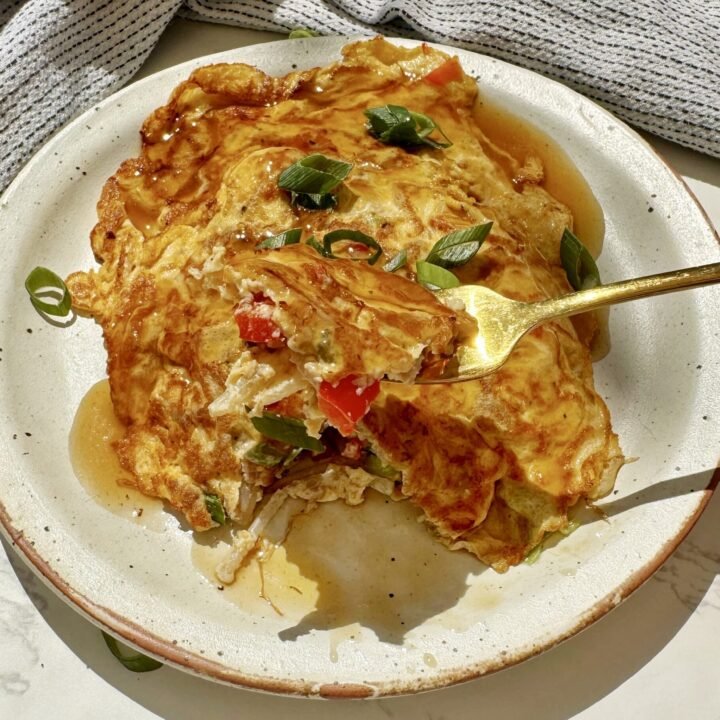 A plate with two egg pancakes containing mince pork and vegetables, called Healthy Minced Pork Egg Foo Young
