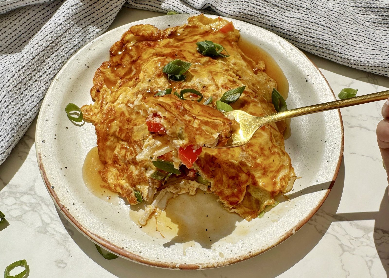 A plate with two egg pancakes containing mince pork and vegetables, called Healthy Minced Pork Egg Foo Young