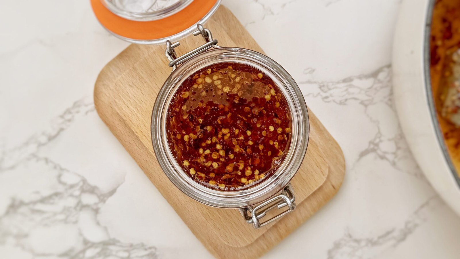 Glass Jar containing Homemade Hot Honey with chilli flakes