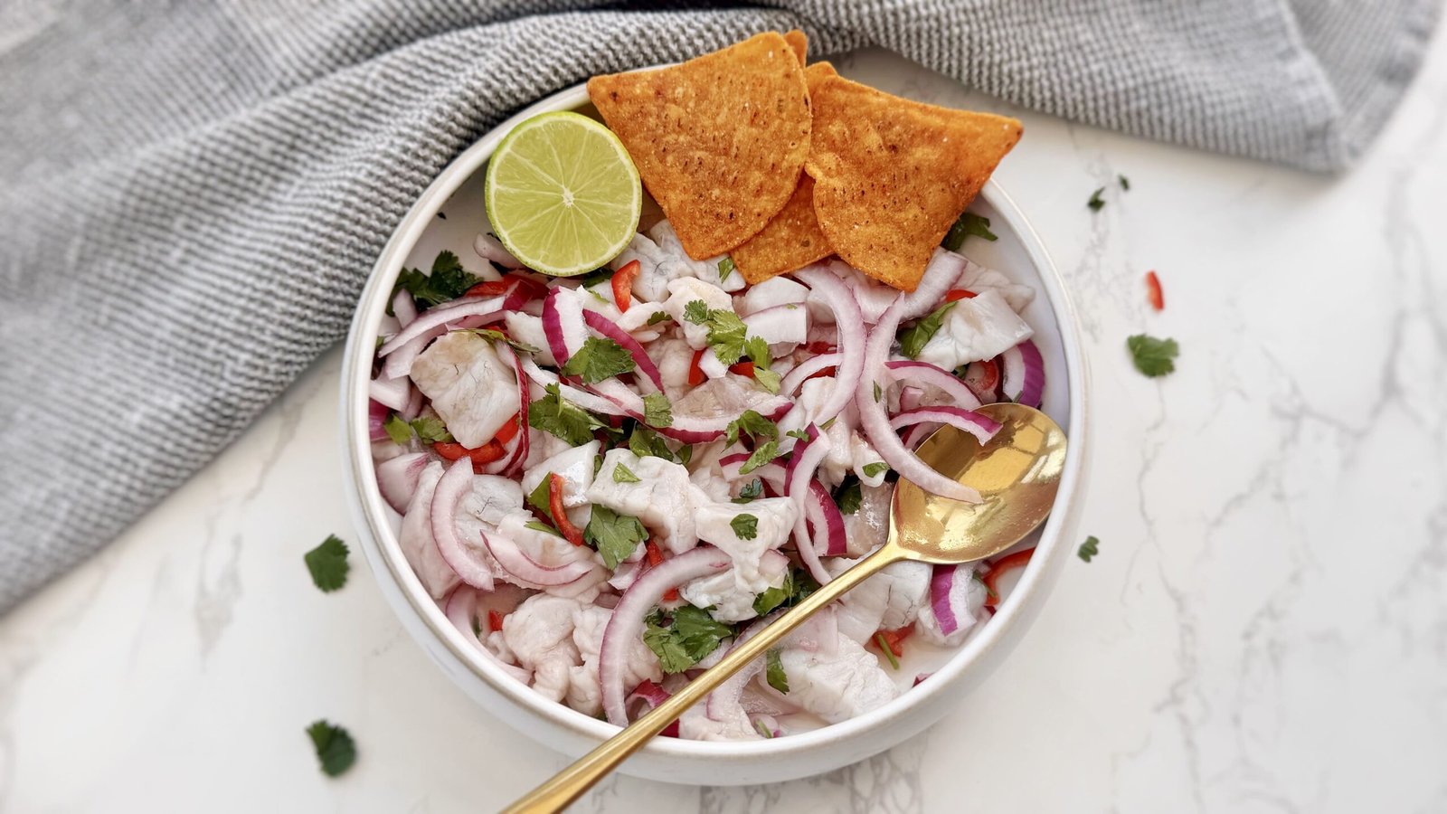 Authentic Peruvian Ceviche with lime-cured fish, red onion, chilli slices, coriander, served with sweet potato and corn