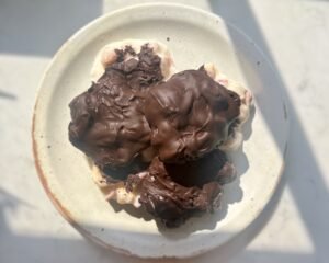 Homemade Peach Clusters with yoghurt and dark chocolate on a tray, chilled and ready to serve