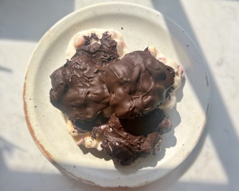 Homemade Peach Clusters with yoghurt and dark chocolate on a tray, chilled and ready to serve