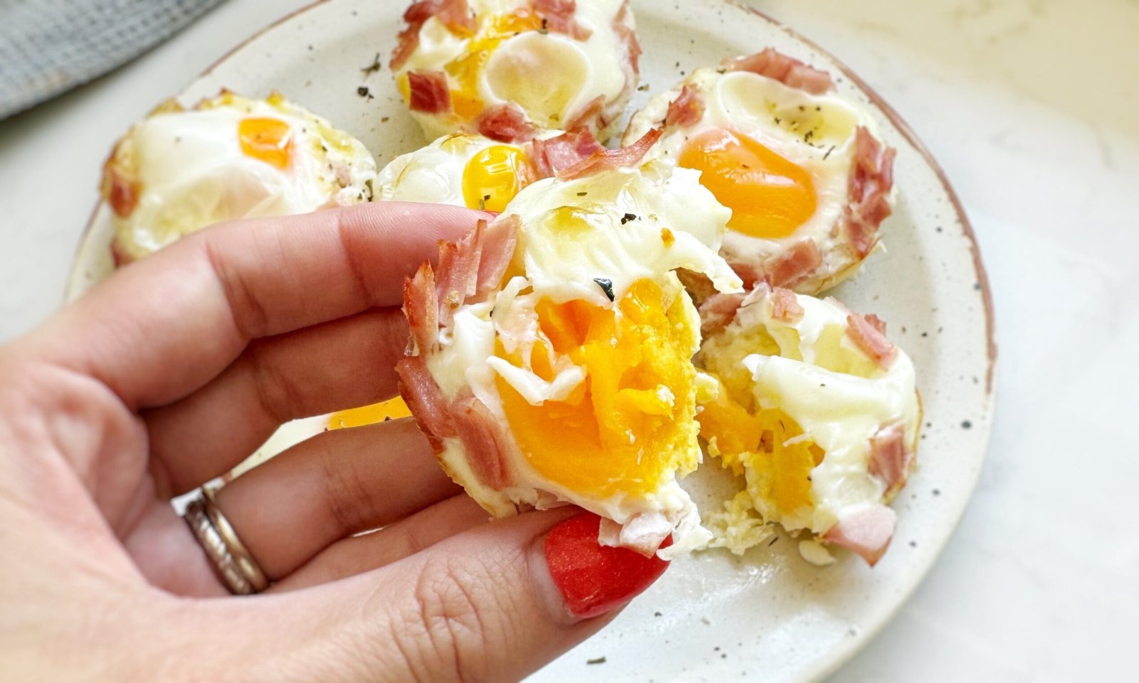 Golden Cheesy Ham Egg Bites baked in a muffin tin – a high-protein, low-carb breakfast or snack option.