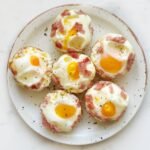 Golden Cheesy Ham Egg Bites baked in a muffin tin – a high-protein, low-carb breakfast or snack option.