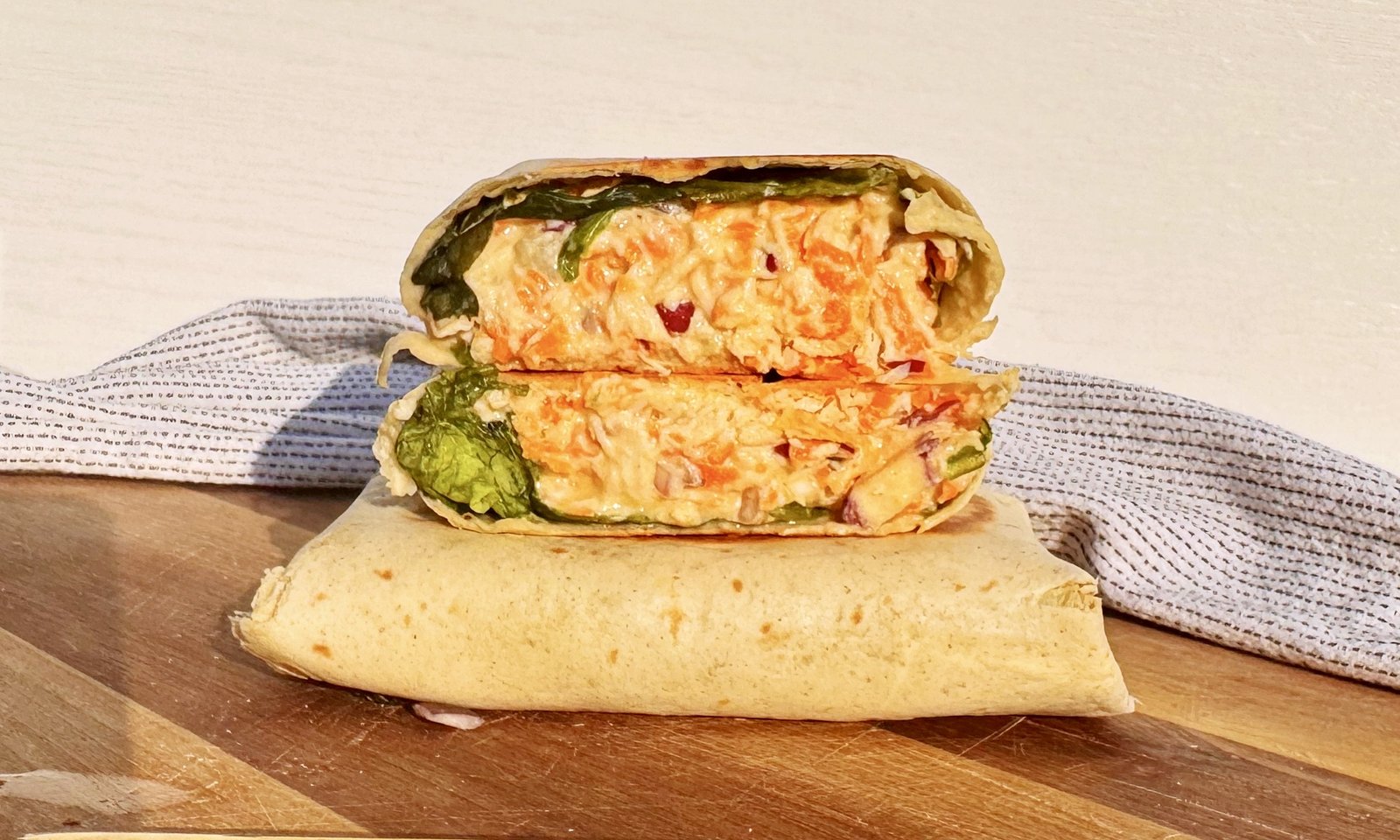 Creamy Honey Mustard Chicken Wrap sliced open with chicken and vegetables