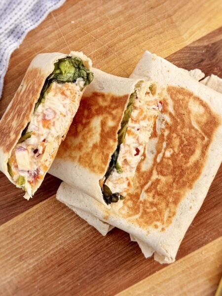Creamy Honey Mustard Chicken Wraps sliced open with chicken and vegetables