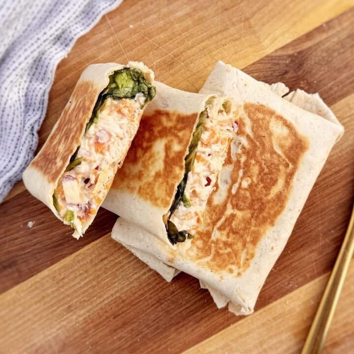 Creamy Honey Mustard Chicken Wraps sliced open with chicken and vegetables