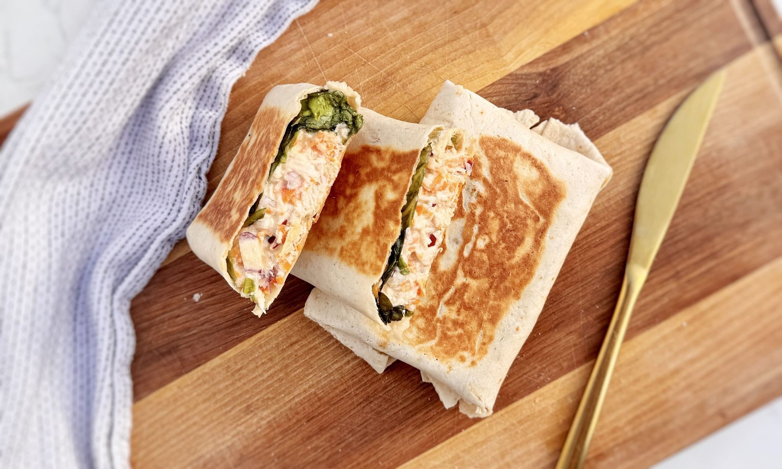 Creamy Honey Mustard Chicken Wraps sliced open with chicken and vegetables