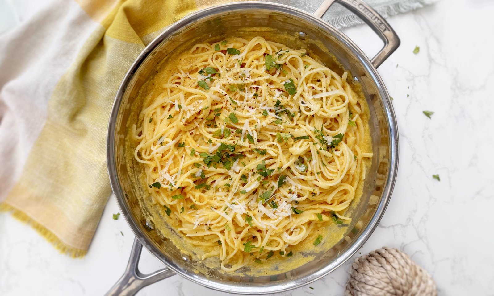 Bowl of creamy roasted pumpkin pasta garnished with parsley