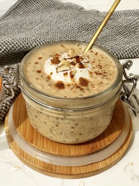 A jar of Pumpkin Spice Latte Overnight Oats topped with cinnamon, showcasing creamy oats with a hint of coffee and fall spices.