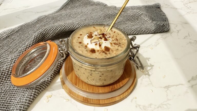 A jar of Pumpkin Spice Latte Overnight Oats topped with cinnamon, showcasing creamy oats with a hint of coffee and fall spices.