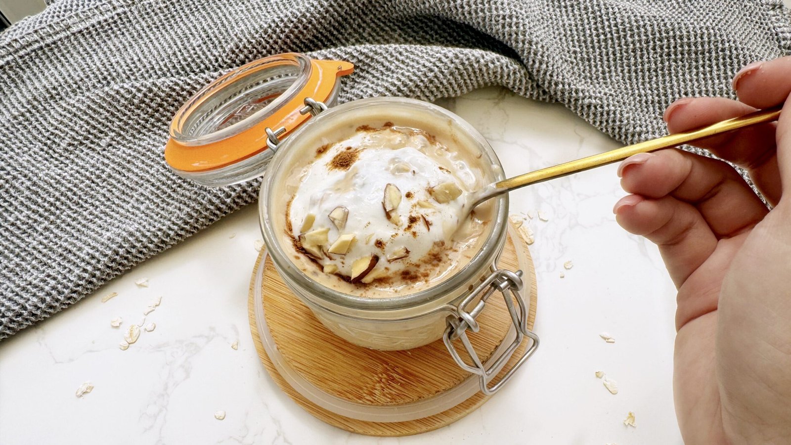 A jar of Pumpkin Spice Latte Overnight Oats topped with cinnamon, showcasing creamy oats with a hint of coffee and fall spices.