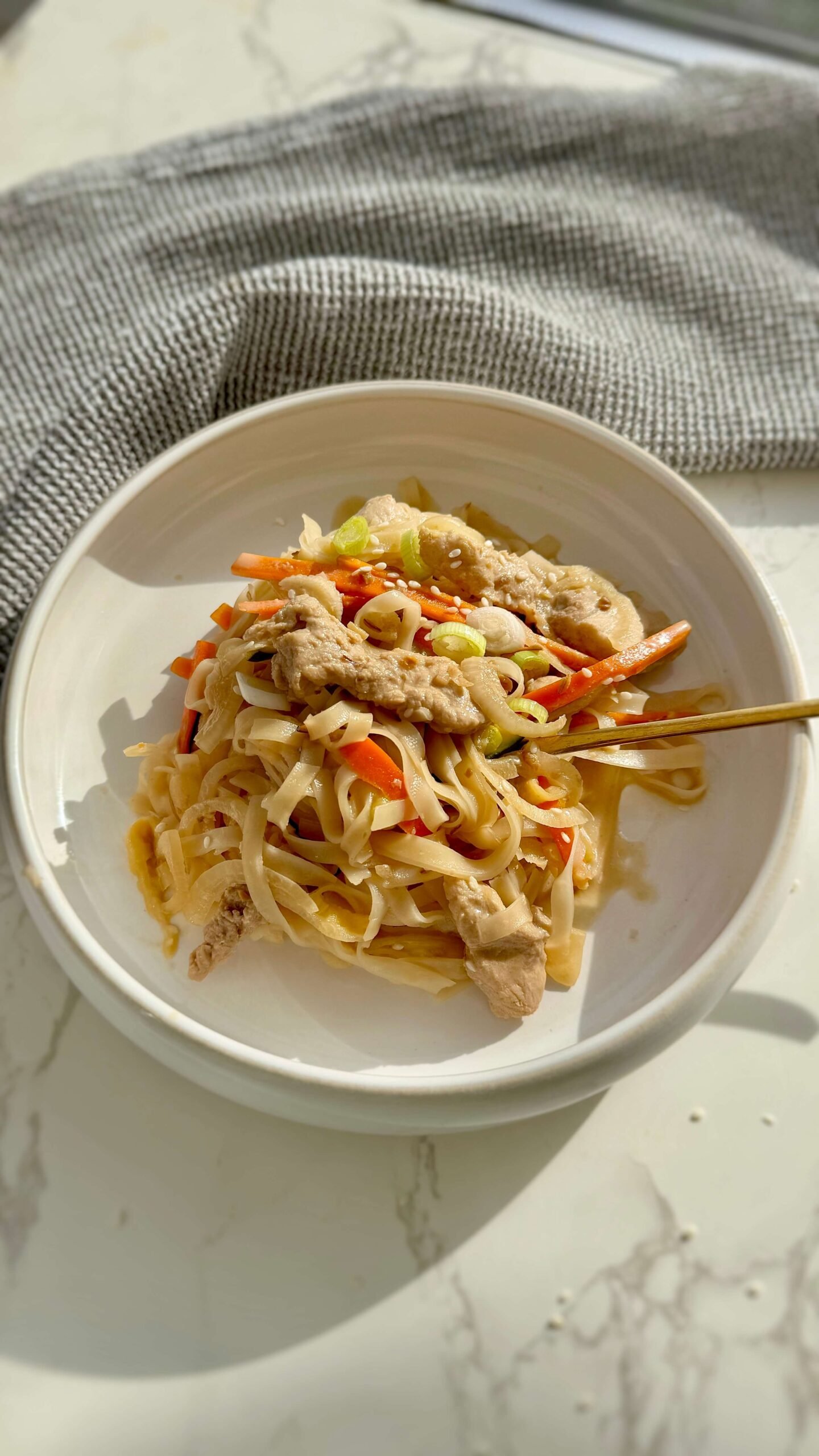 Slow Cooker Creamy Miso Pork Noodles served in a bowl with a fork