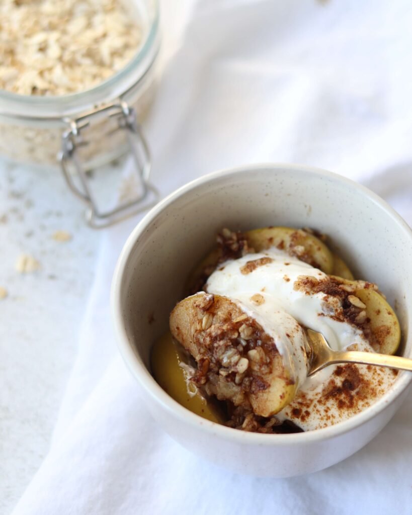 Single serve apple crisp in a small bowl topped with Skyr