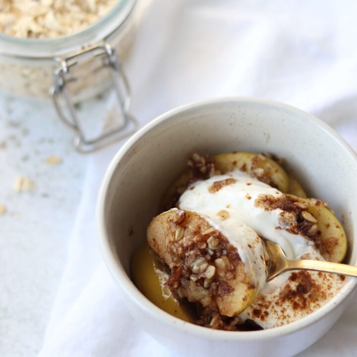 Single serve Skillet Apple Crisp serve in a small bowl topped with yoghurt