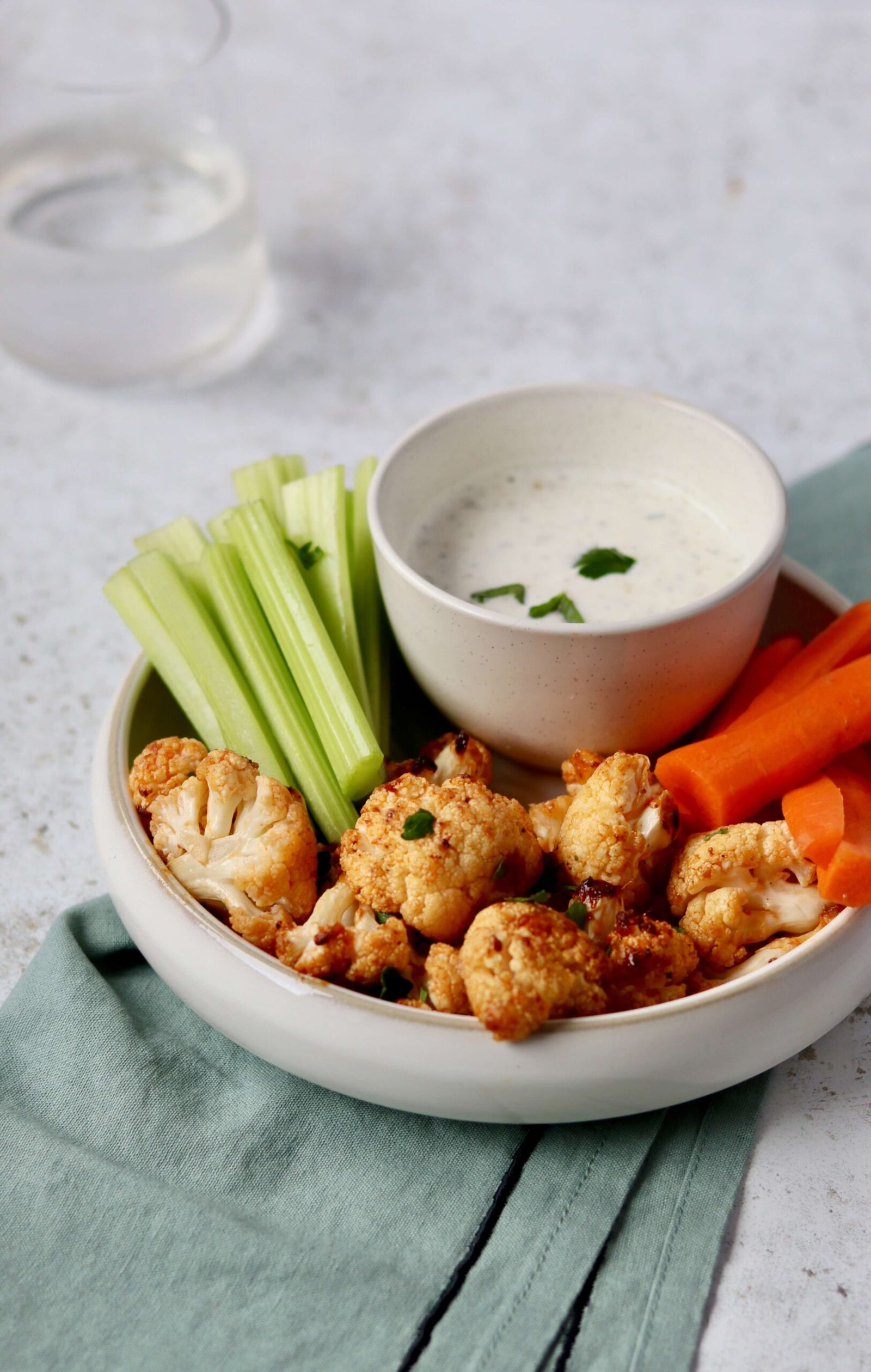 Parmesan Cauliflower Buffalo Bites with Greek Yogurt Ranch view from the side above
