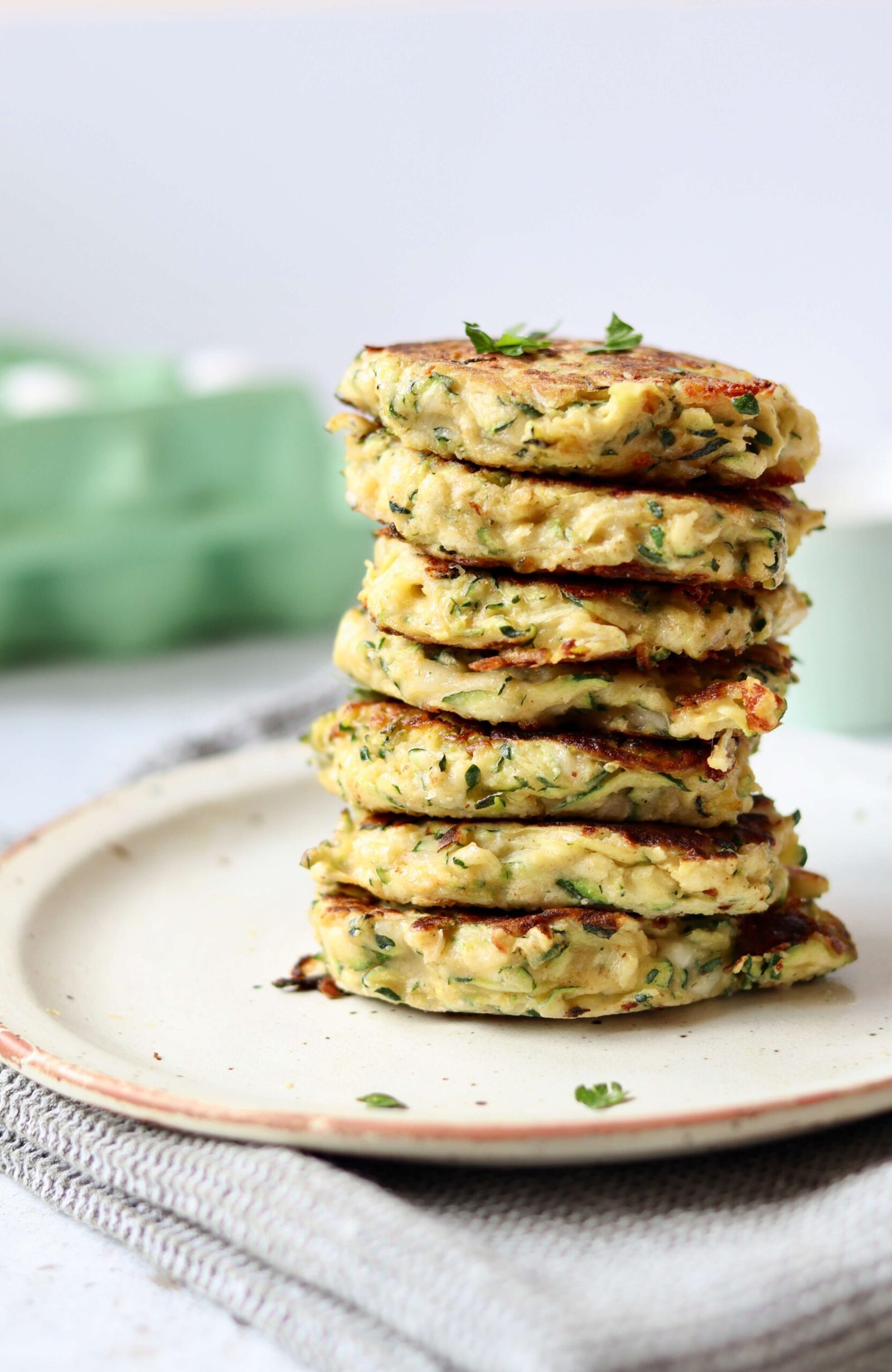 Cheesy Zucchini Fritters with Herbed Greek Yogurt Dip view straight from side