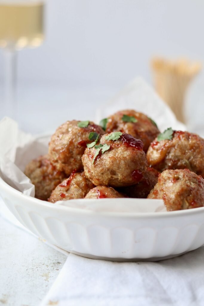 Mini Turkey Meatballs with Cranberry Glaze served in a bowl view from side