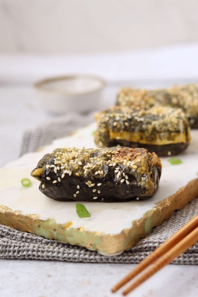 Crispy Spicy Tuna Rice Paper Rolls served on a board close up