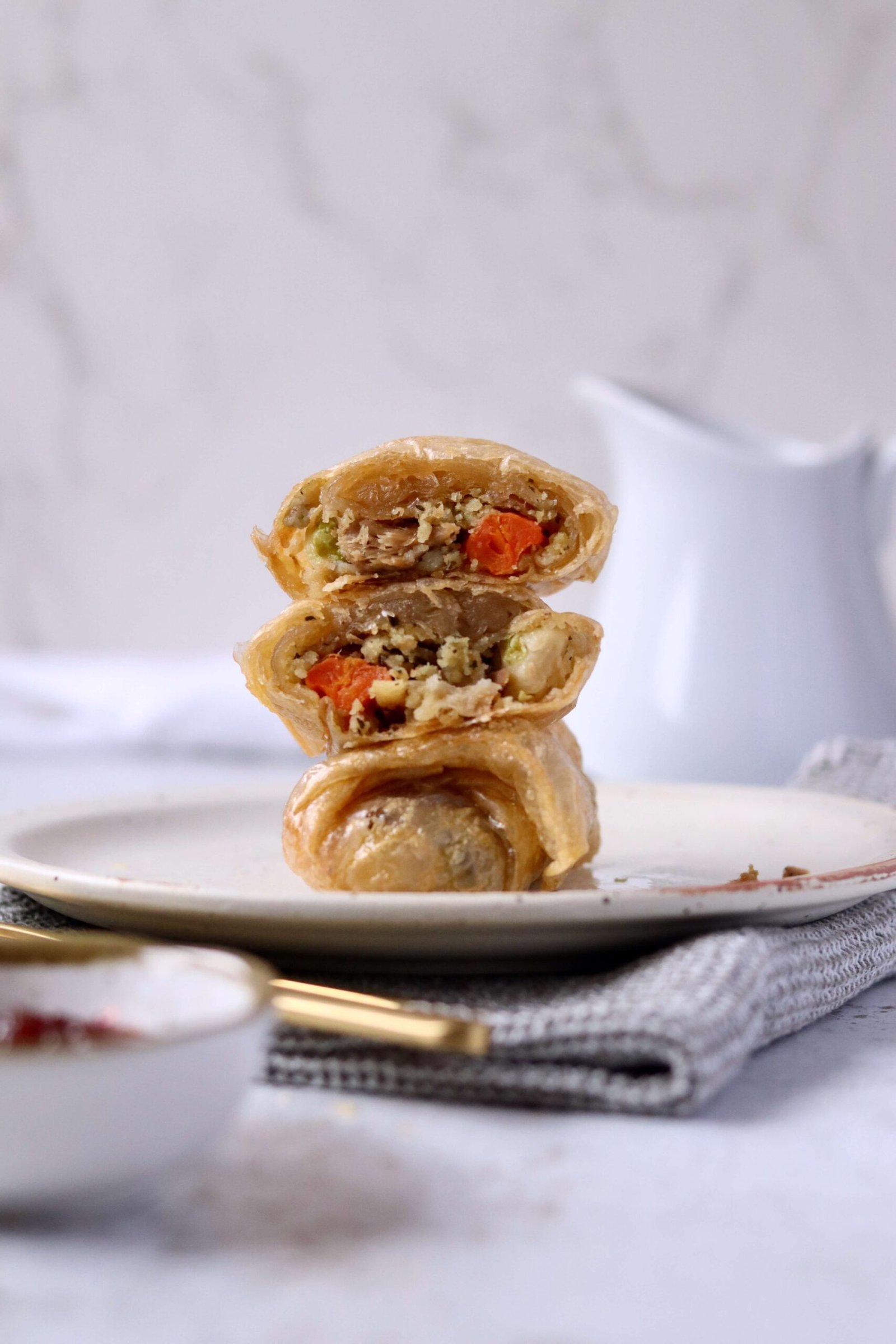 Crispy Roast Dinner Spring Rolls arranged on top of another