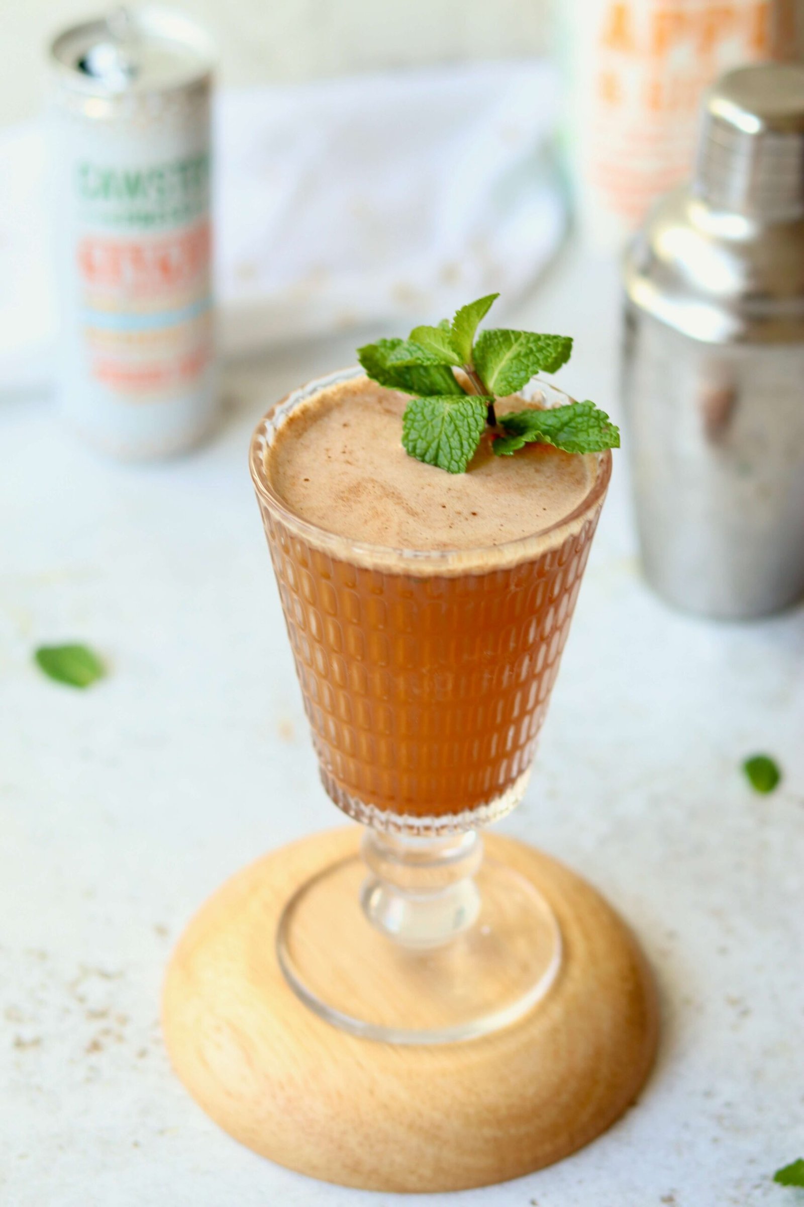 Apple and Ginger Fizz Mocktail, served in glass with mint garnish, closeup