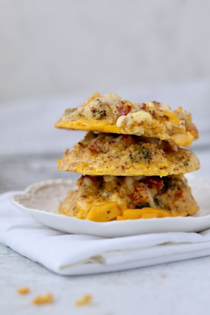 3 egg biscuits stacked over another. served on a plate and viewed from side