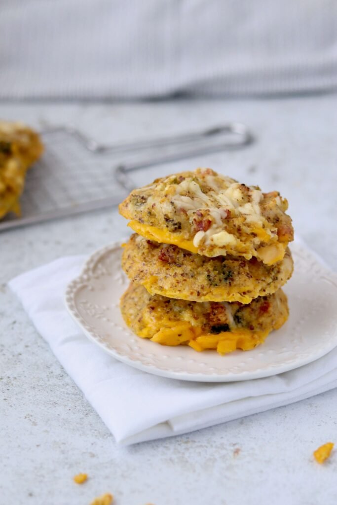3 egg biscuits stacked over another. served on a plate and viewed from side