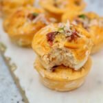 High Protein Cottage cheese egg muffins, two muffins, one has been bitten into showing internal texture