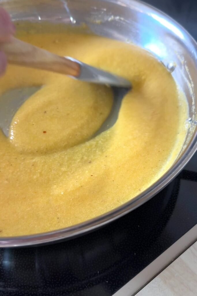 Smooth roasted pumpkin and cottage cheese sauce poured into a pan