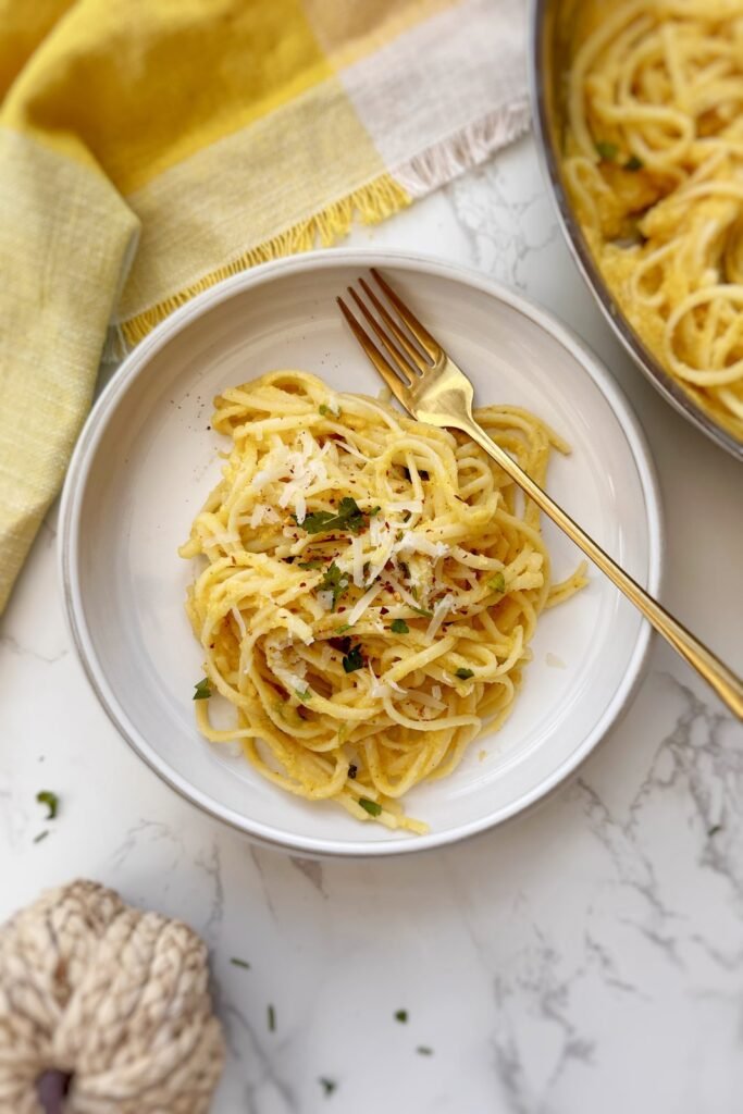 Bowl of creamy roasted pumpkin pasta with parmesan and parsley