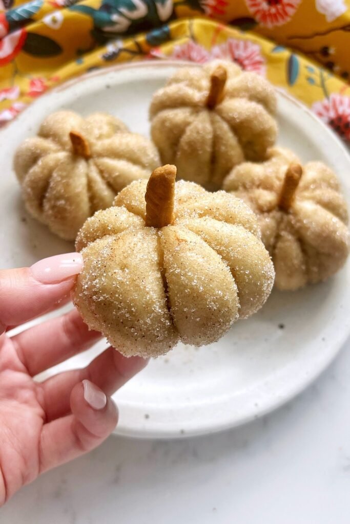 Pumpkin spice steamed buns shaped like mini pumpkins on a plate