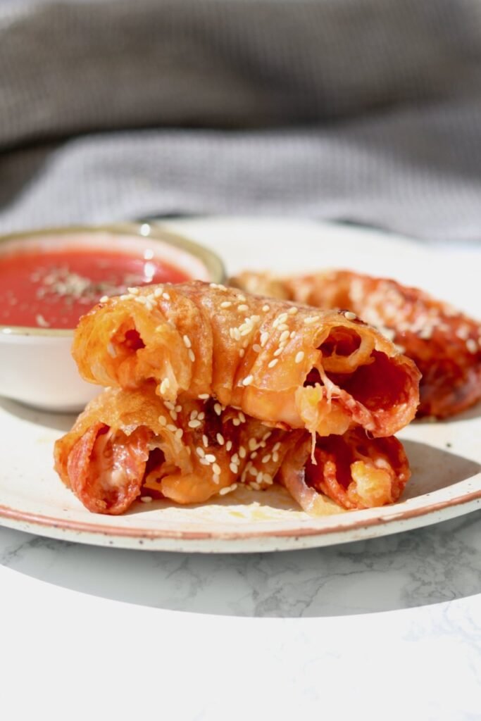 Inside a rice paper pizza bagel showing pepperoni and melted cheese