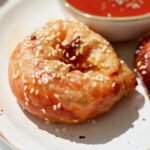 Rice paper pizza bagels on a plate with a bowl of passata dipping sauce