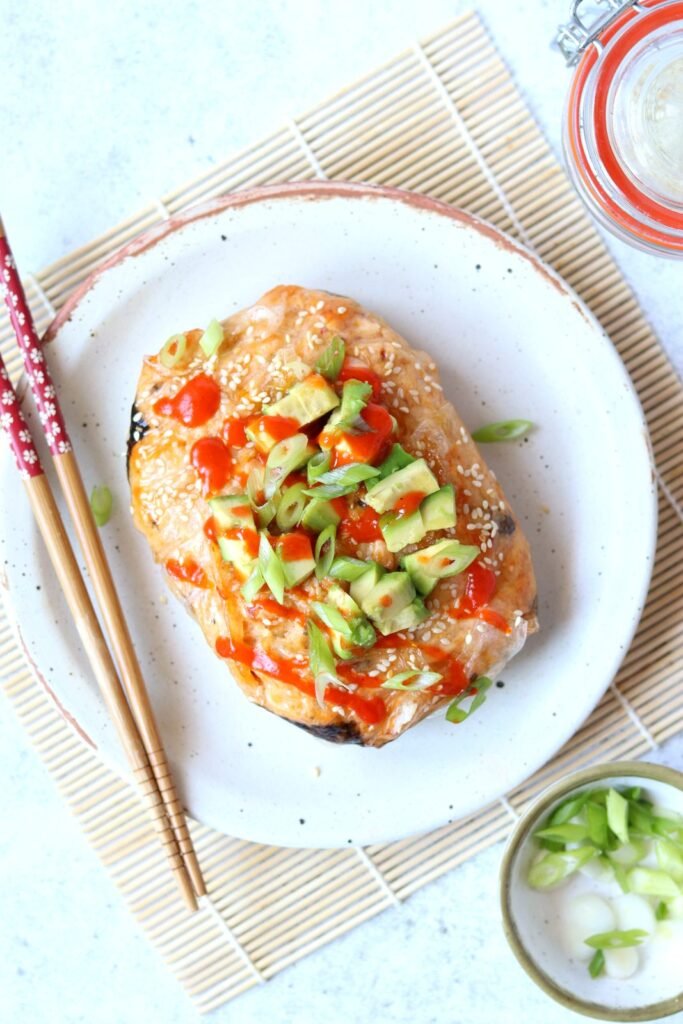 Cross section of the sushi bake showing layers of sushi rice, nori and spicy salmon