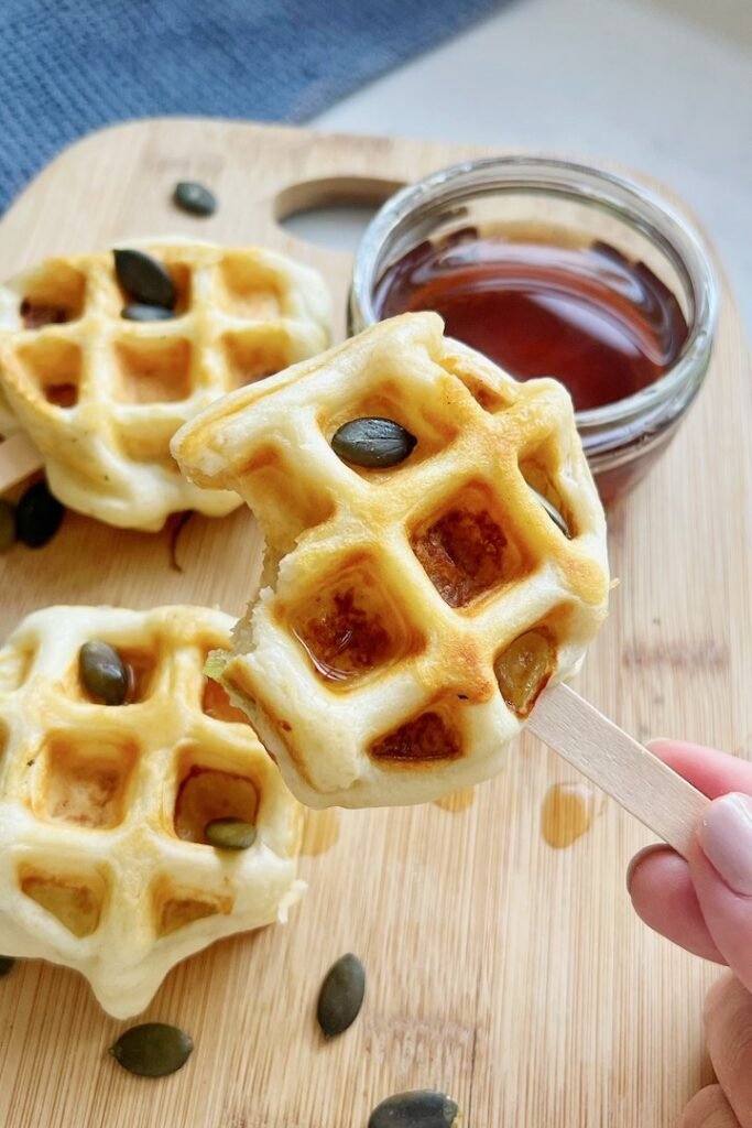 Maple syrup dripping from an apple waffle pop