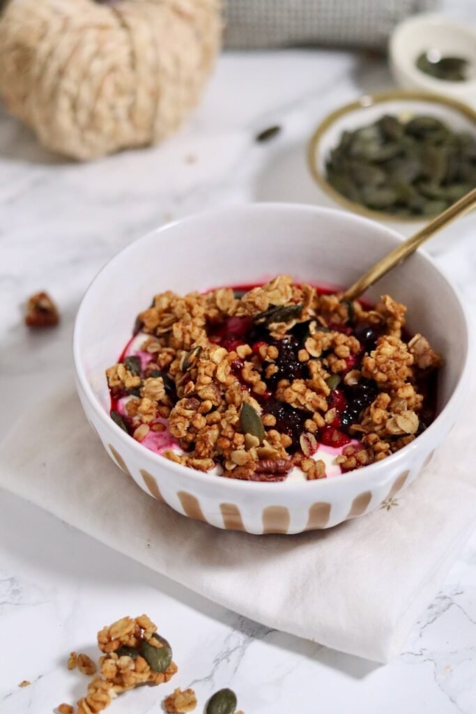 High protein granola served over yoghurt with fresh berries